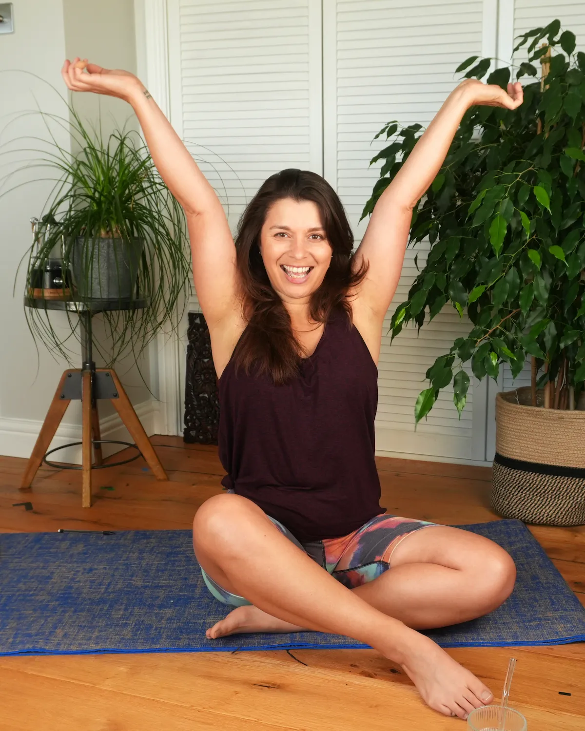 Physiotherapist, Hollie at the Gentle Physio Studio, sitting cross legged with elbows extended showing hypermobility.